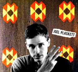 Joel Plaskett Three album cover featuring Joel's name and Joel holding up 3 fingers on an ornate background